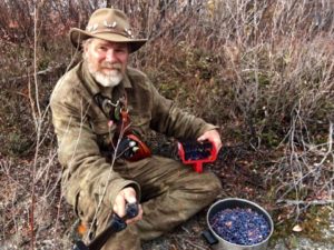 The Last Frontiersman, Dan McDowell picking blueberries in Alaska